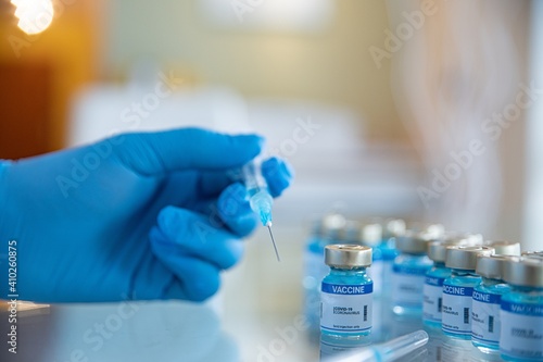 Doctor preparing the coronavirus COVID-19 vaccine. Ampoules with Covid-19 vaccine in laboratory. Coronavirus pandemic.