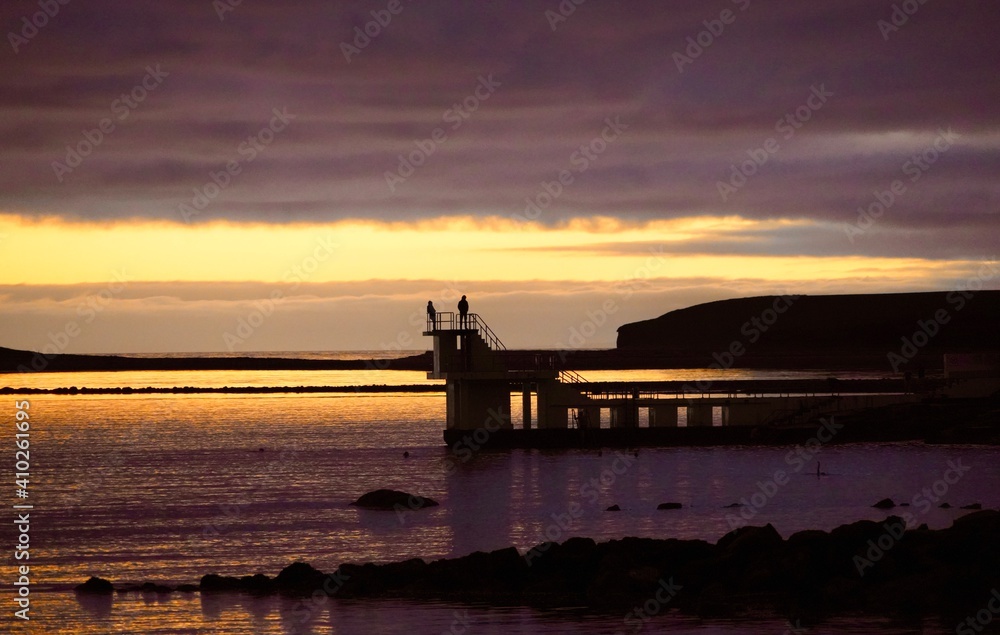 silhouettes of people on Blackrock diving tower on Salthill promenade in Galway silhouettes of people on Blackrock diving tower on Salthill promenade in Galway