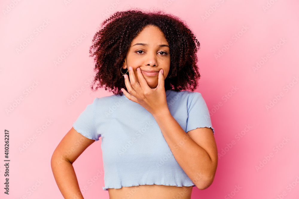 Young african american mixed race woman isolated doubting between two options. Young african american mixed race woman isolated doubting between two options.