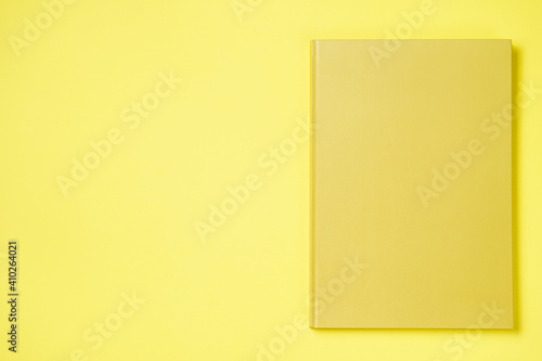 Leather notebook cover on a paper yellow background, notepad mock up, top view shot