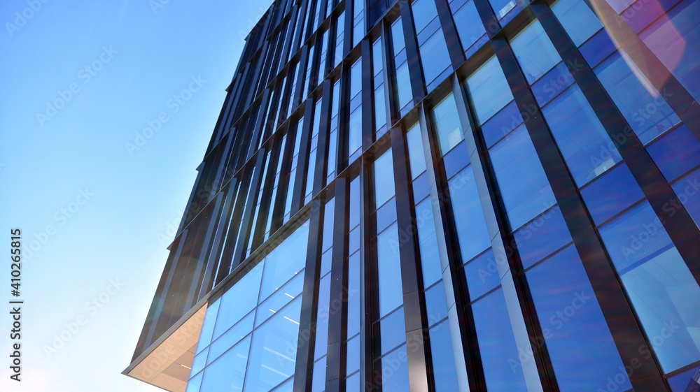 Obraz premium Glass facade of the buildings with a blue sky. Skyscrapers in the business city center.. Background of modern glass buildings. 