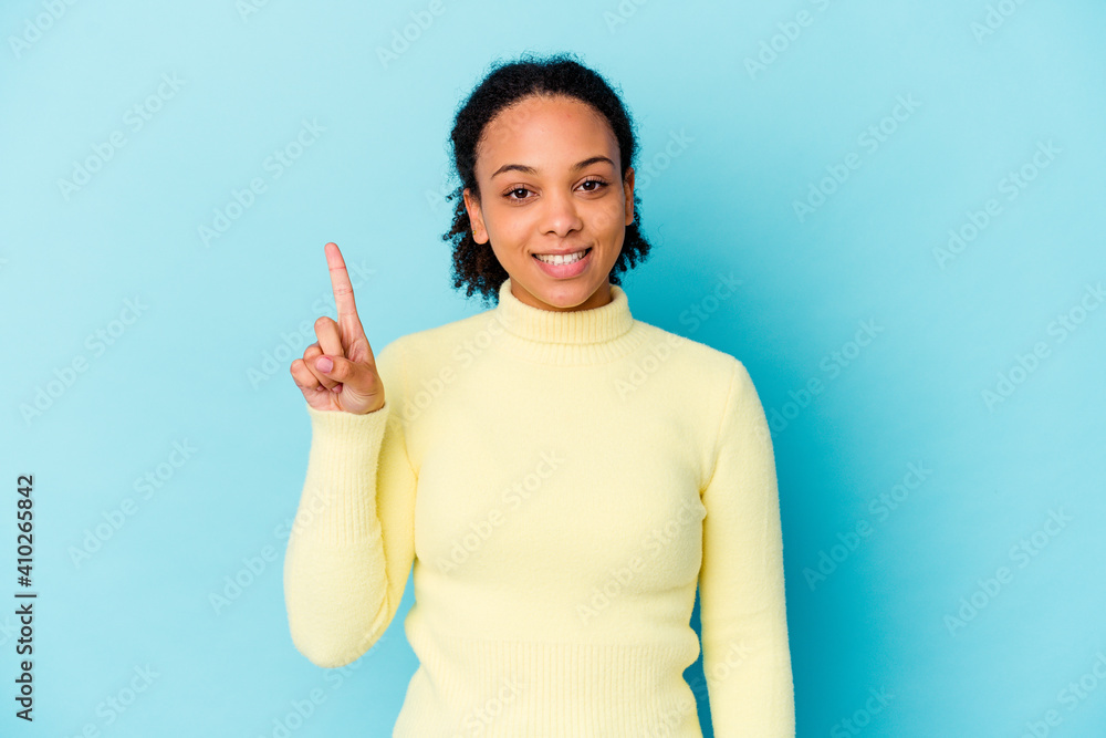 Young african american mixed race woman isolated showing number one with finger. Young african american mixed race woman isolated showing number one with finger.