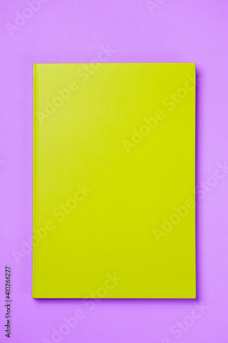 Green Leather notebook on paper pink background, notepad mock up, top view shot
