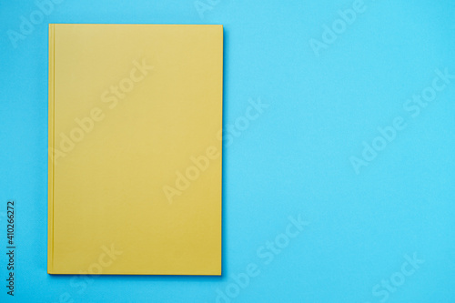Green Leather notebook on paper blue background, notepad mock up, top view shot
