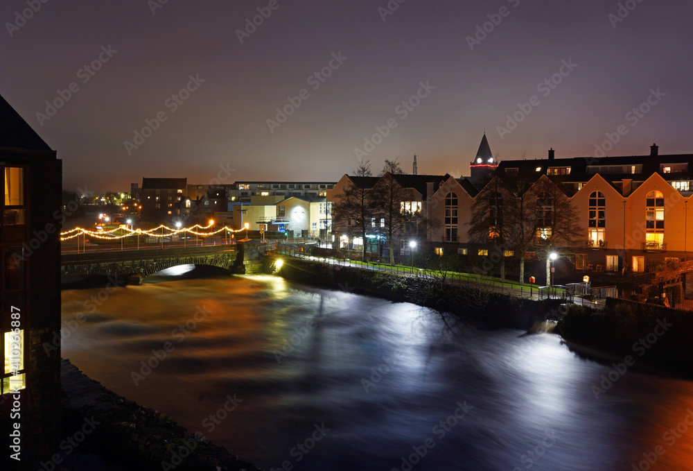 Long exposure photo of rushing water at O'Brien's bridge on the river Corrib at night in Galway city
