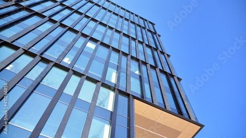 Glass facade of the buildings with a blue sky. Skyscrapers in the business city center.. Background of modern glass buildings. 