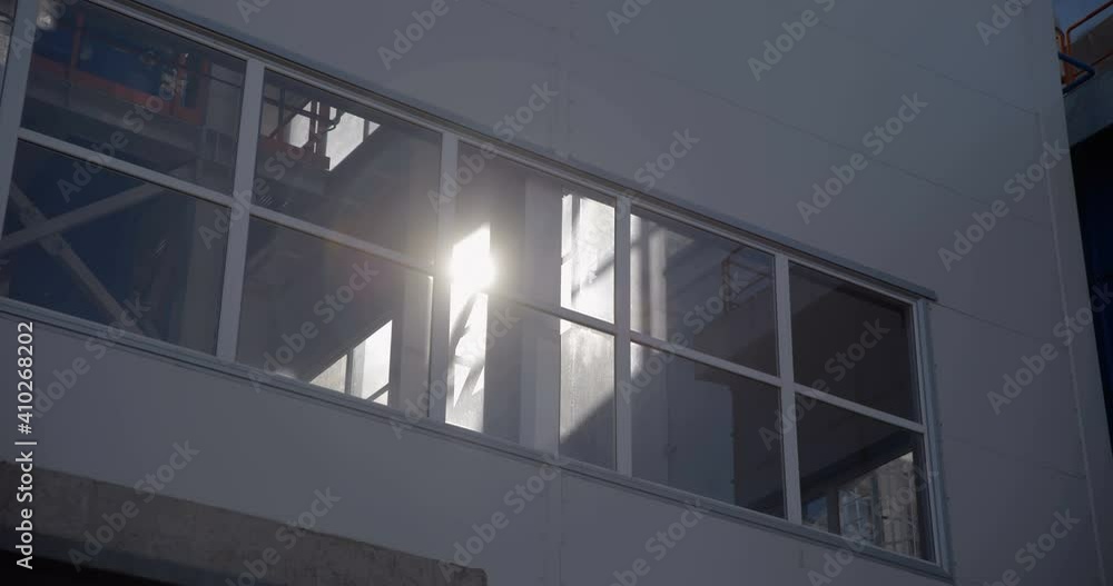 A ray of sun shines through the large windows in the factory A ray of sun shines through the large windows in the factory