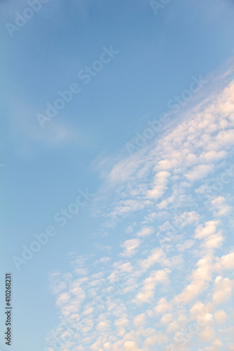Small white clustered clouds in a blue sky