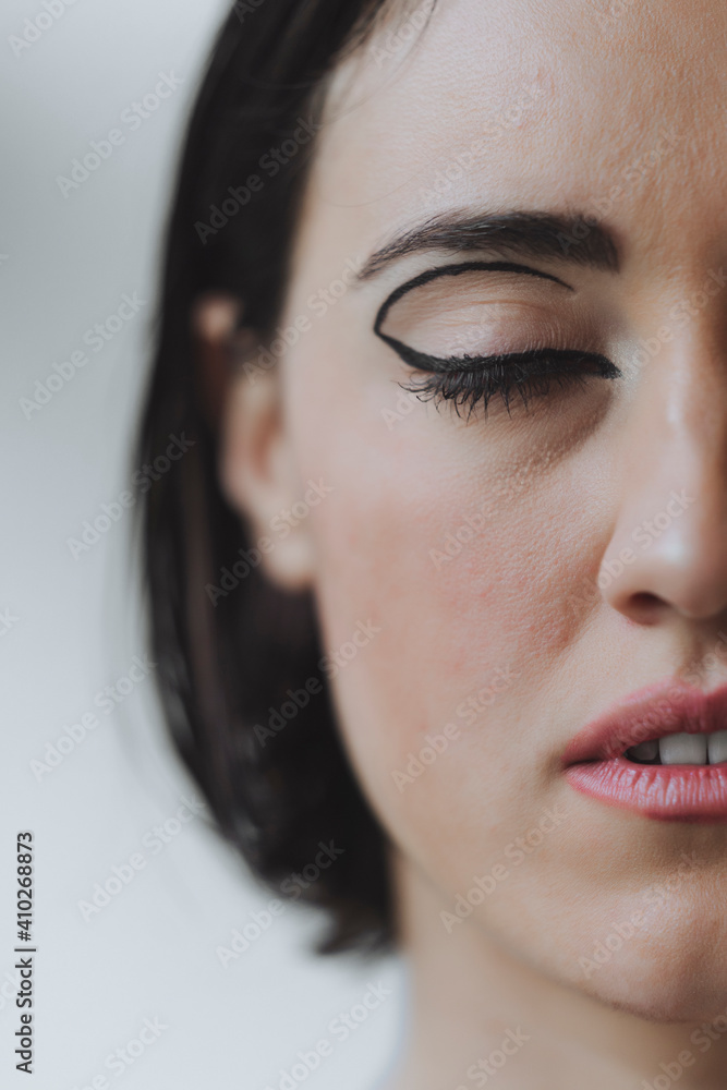 Close-up of ballerina with make-up closing eyes in studio Close-up of ballerina with make-up closing eyes in studio