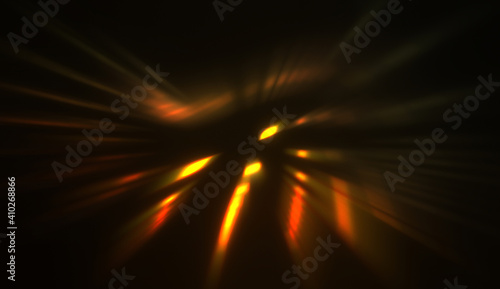 Light particles in motion, creating a burst of glowing multicolored rays on a black background. Energetic glow lights wallpaper.