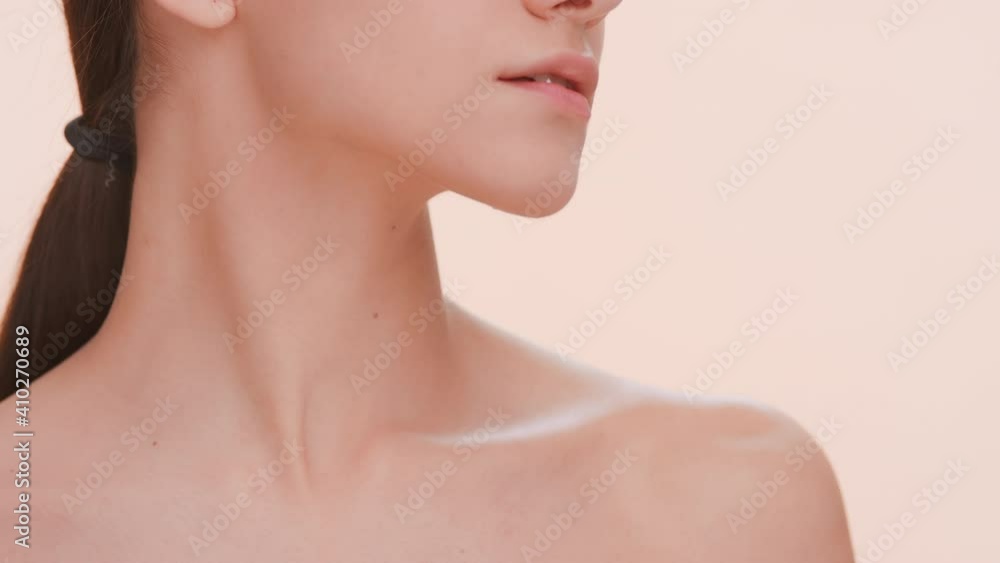 Close-up beauty portrait of young good-looking woman with a pure skin who gently strokes her clavicles | Beauty care concept Close-up beauty portrait of young good-looking woman with a pure skin who gently strokes her clavicles | Beauty care concept