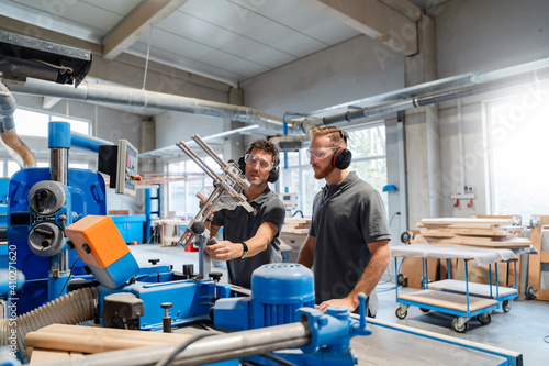 Wallpaper Mural Two male carpenters talking in production hall Torontodigital.ca