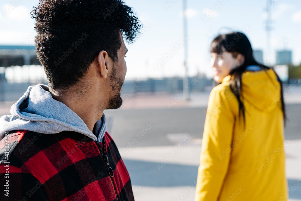 Man looking at friend while standing outdoors Man looking at friend while standing outdoors