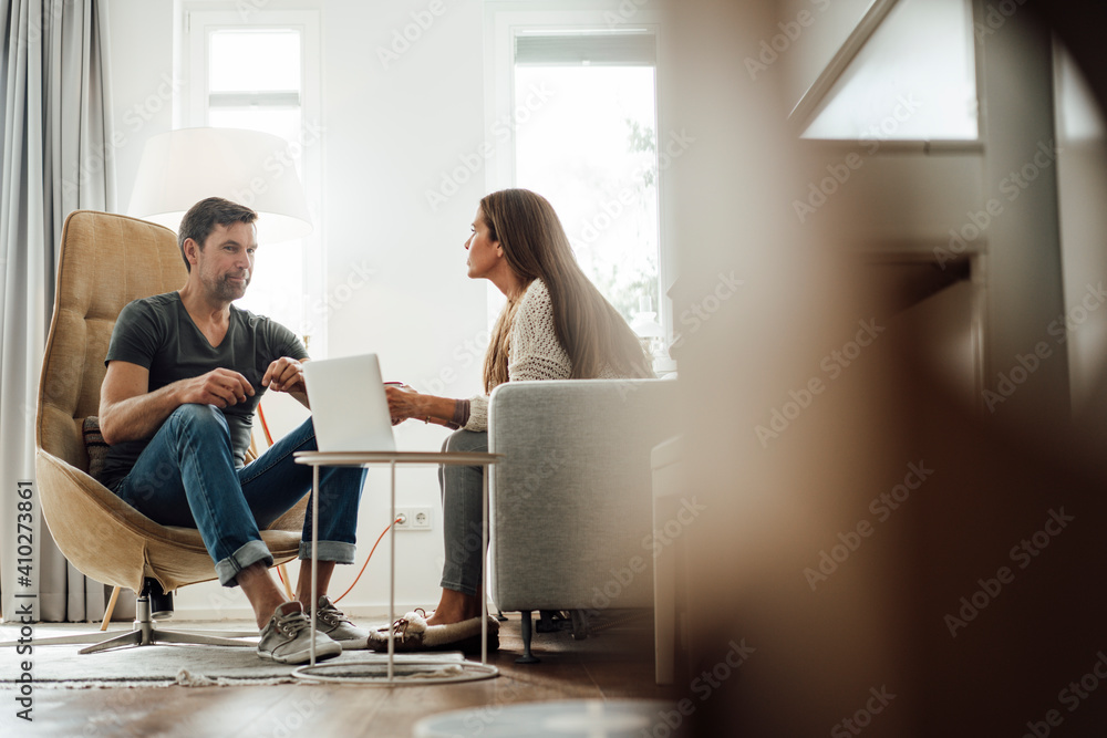 Mature man talking to woman in apartment Mature man talking to woman in apartment