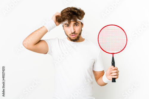 Young indian man playing badminton being shocked, she has remembered important meeting. © Asier