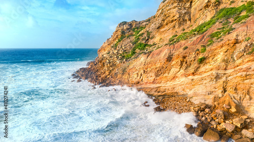 Cape Cabo Espichel at sunset with cliffs and Atlantic ocean landscape. Western coast of Eurasia. Sesimbra, coastline of Portugal