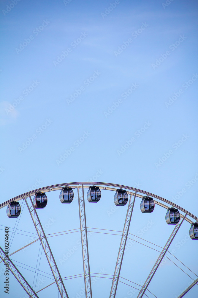 Minimal Top of Large Ferris Wheel in Blue Sky Minimal Top of Large Ferris Wheel in Blue Sky