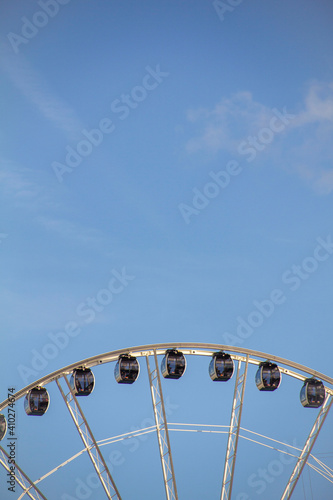 Top of Large Ferris Wheel in Blue Sky During Sunset