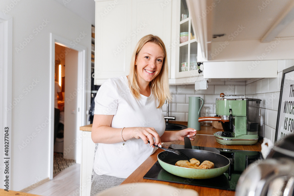 Portrait of smiling woman cooking Portrait of smiling woman cooking