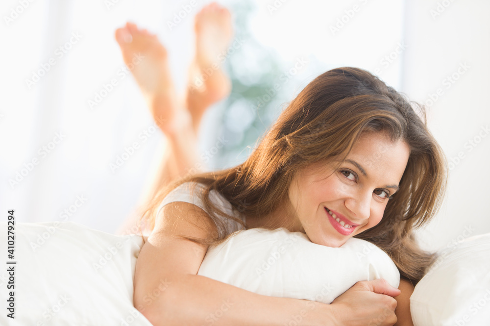 Happy woman lying on bed Happy woman lying on bed