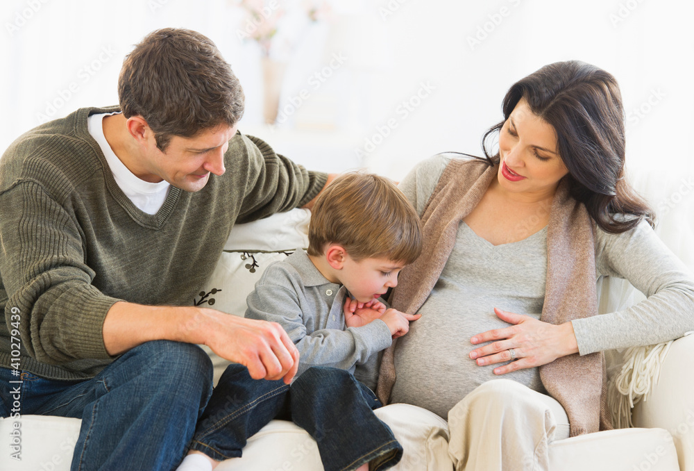 Boy (4-5) touching pregnant mother's belly Boy (4-5) touching pregnant mother's belly