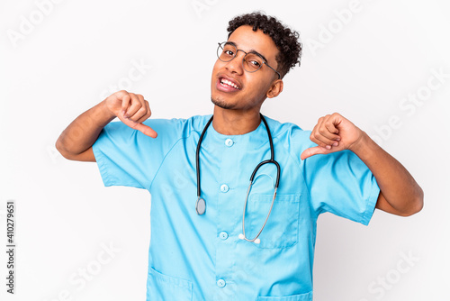 Young african american curly nurse man isolated feels proud and self confident, example to follow.