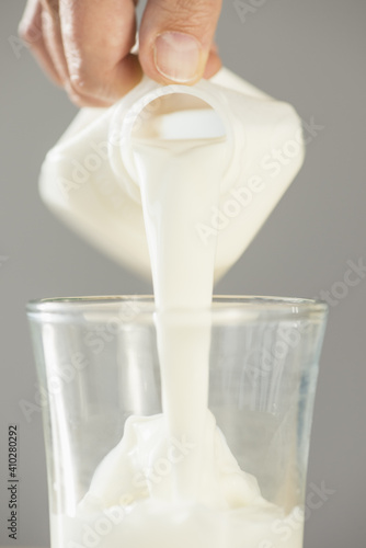 Hand pouring milk photo