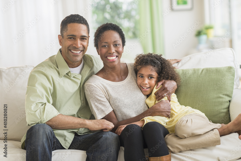 Portrait of parents with daughter (6-7) on sofa Portrait of parents with daughter (6-7) on sofa