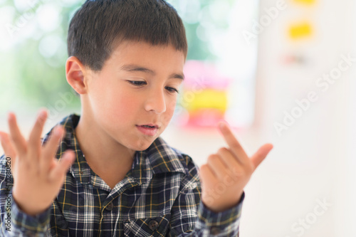 Boy (6-7) counting on fingers