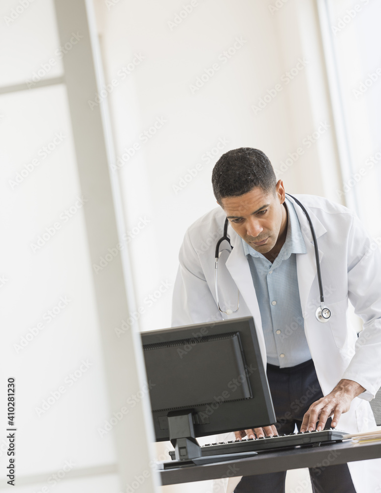 Male doctor using computer in his office Male doctor using computer in his office