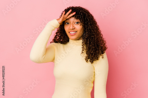 Young african american afro woman isolated shouts loud, keeps eyes opened and hands tense. © Asier