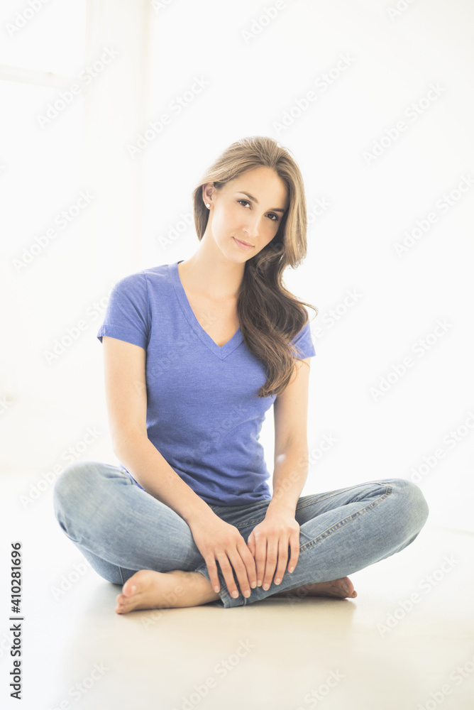 Portrait of young woman sitting on floor Portrait of young woman sitting on floor
