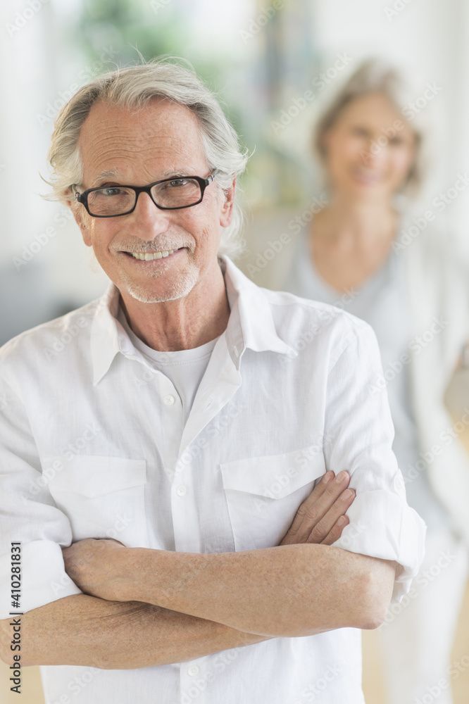Portrait of senior man, woman in background Portrait of senior man, woman in background