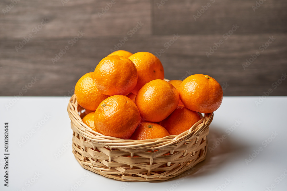 Basket with tangerines on a light background Basket with tangerines on a light background