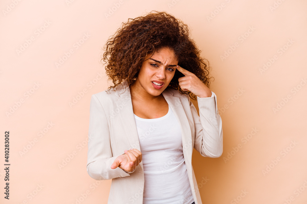 Young african american woman isolated on beige background showing a disappointment gesture with forefinger. Young african american woman isolated on beige background showing a disappointment gesture with forefinger.