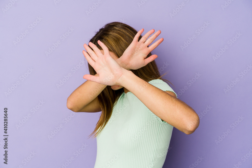 Young skinny caucasian girl teenager on purple background keeping two arms crossed, denial concept. Young skinny caucasian girl teenager on purple background keeping two arms crossed, denial concept.