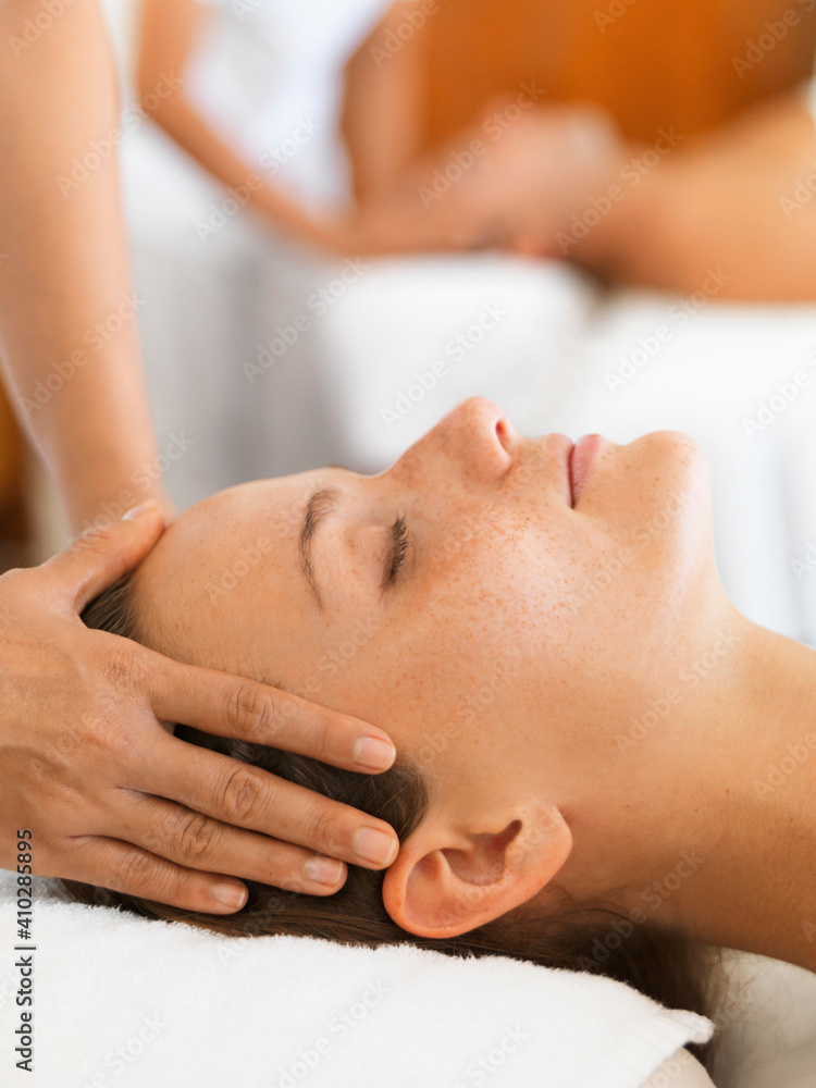 Two people getting massage in spa Two people getting massage in spa