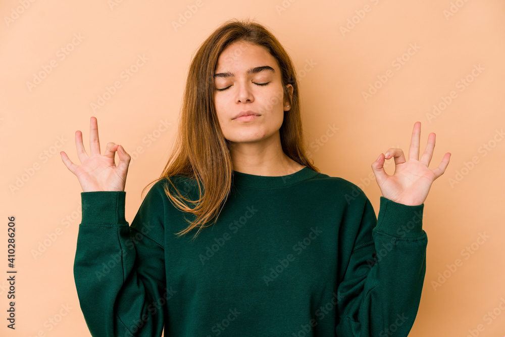 Young skinny caucasian teenager girl relaxes after hard working day, she is performing yoga. Young skinny caucasian teenager girl relaxes after hard working day, she is performing yoga.