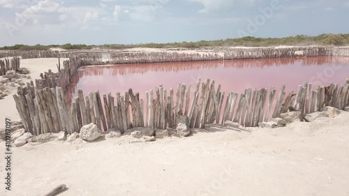 Salt ponds with pink water that the Mayans have mined since ancient time. photo