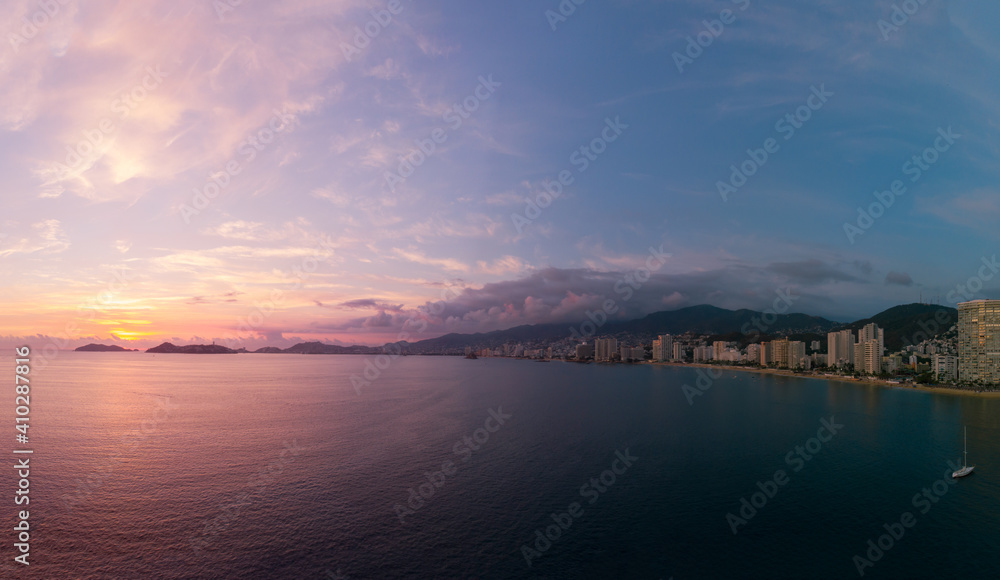Beautiful sunset, aerial view of the beach, acapulco city seen from above. Travel and vacation concept. Colorful sunset on the beach