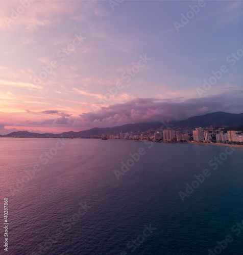 Beautiful sunset, aerial view of the beach, acapulco city seen from above. Travel and vacation concept. Colorful sunset on the beach