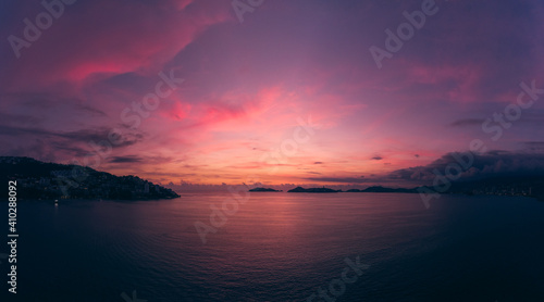Fototapeta Naklejka Na Ścianę i Meble -  Beautiful sunset, aerial view of the beach, acapulco city seen from above. Travel and vacation concept. Colorful sunset on the beach