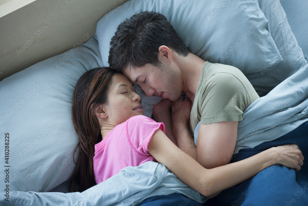 Elevated view of couple sleeping Elevated view of couple sleeping