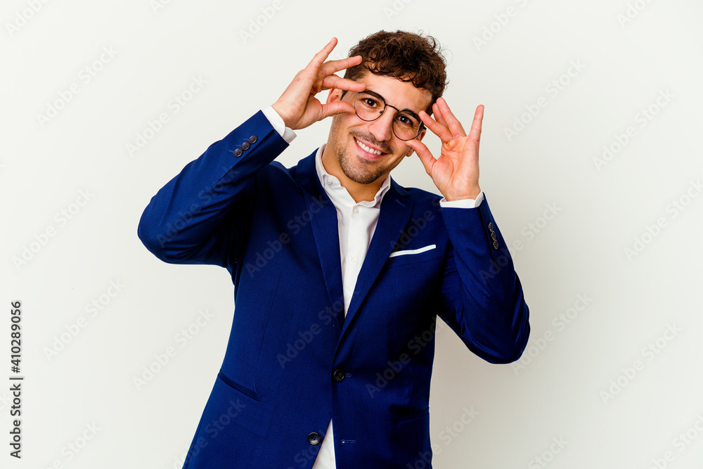 Young business caucasian man isolated on white background showing okay sign over eyes Young business caucasian man isolated on white background showing okay sign over eyes