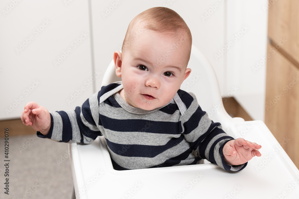 Portrait of a Happy Baby in the Highchair Portrait of a Happy Baby in the Highchair