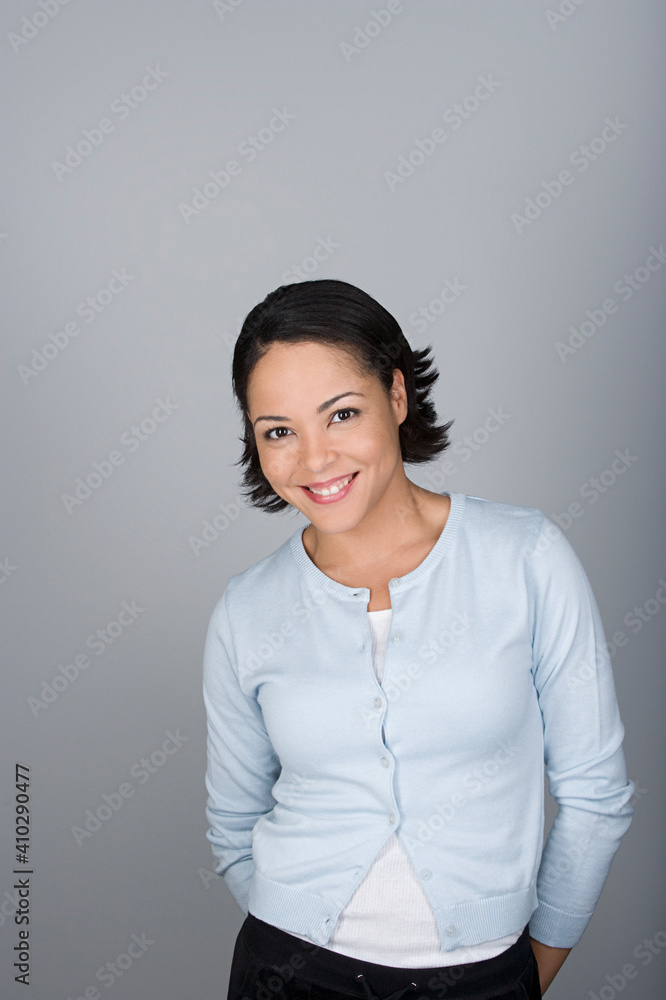 Studio shot portrait of smiling mid adult woman, waist up Studio shot portrait of smiling mid adult woman, waist up