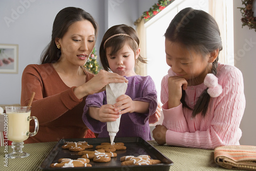 Wallpaper Mural Mother and daughters (10-11) preparing cakes Torontodigital.ca