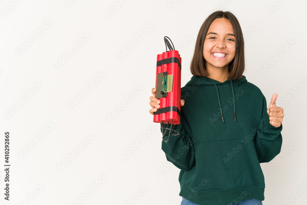 Young hispanic woman holding dynamite smiling and raising thumb up Young hispanic woman holding dynamite smiling and raising thumb up