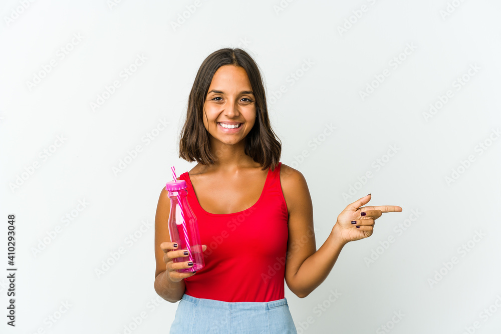 Young latin woman holding a milkshake isolated on white background Young latin woman holding a milkshake isolated on white background