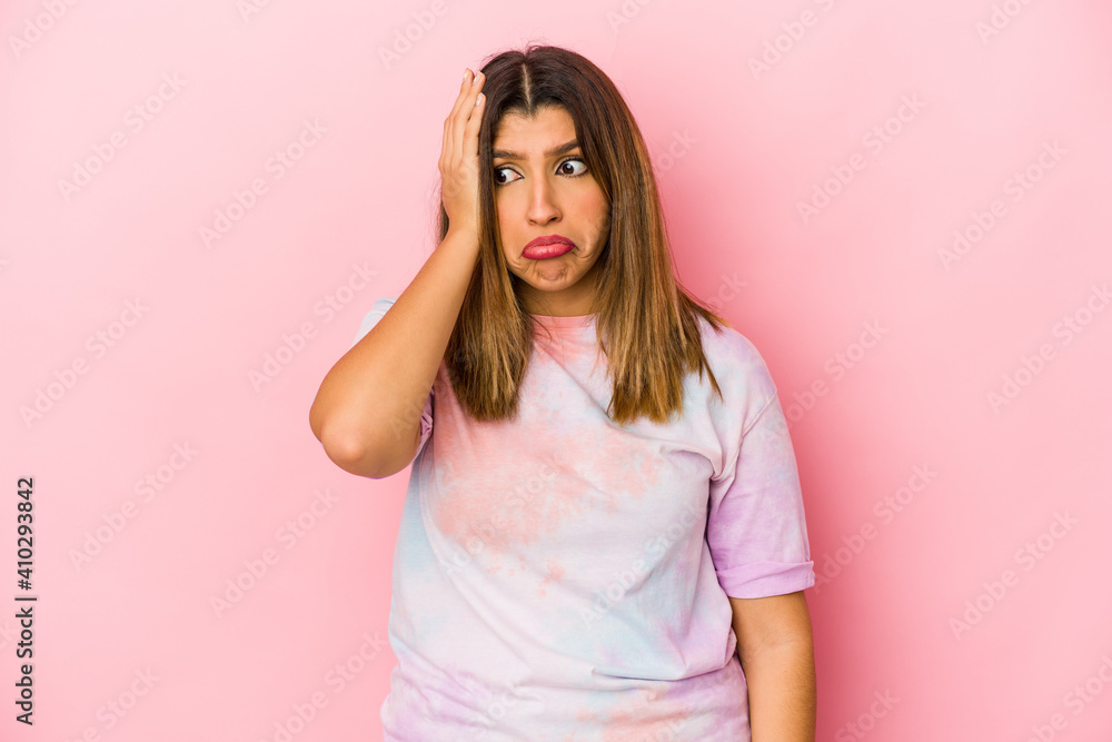 Young indian woman isolated on pink background tired and very sleepy keeping hand on head.